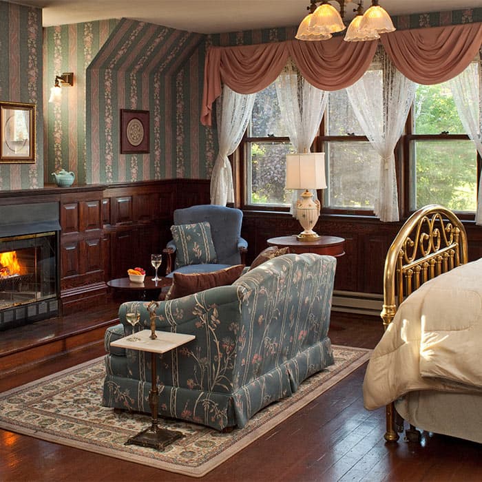 Ballroom at Le Chateau fireplace, couch, and bed