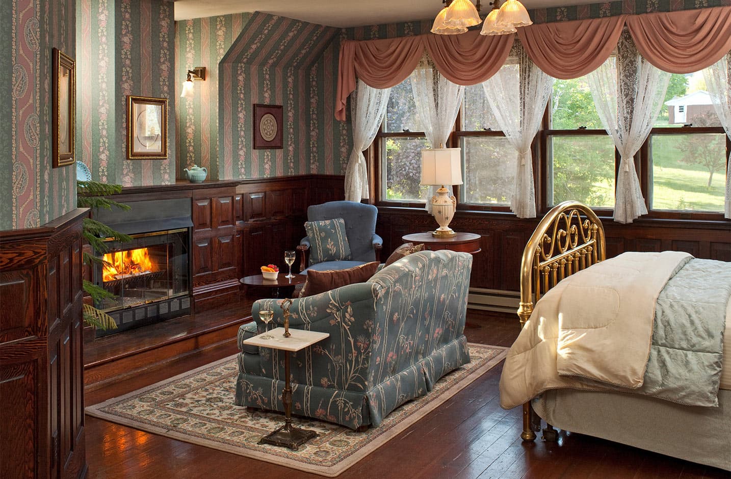 Ballroom at Le Chateau fireplace, couch, and bed