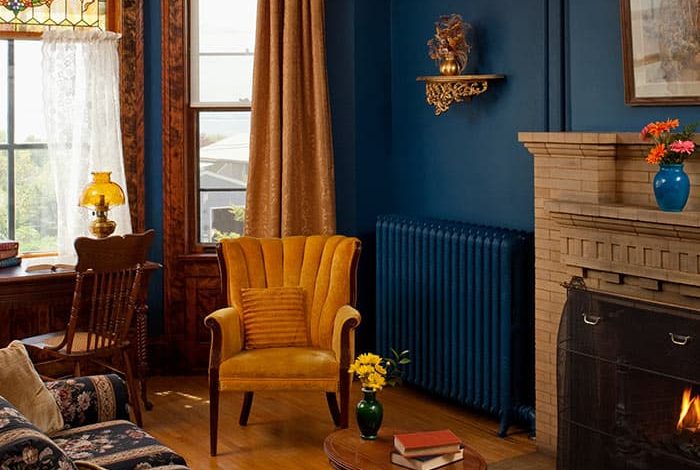 Sitting Room with couch, desk, yellow chair, and fireplace