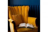 Closeup of yellow chair against blue wall, with open book