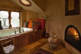 Elevated spa tub and fireplace in Moroccan Suite