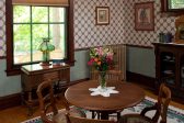 Dining table set with flowers and ornate radiator in background