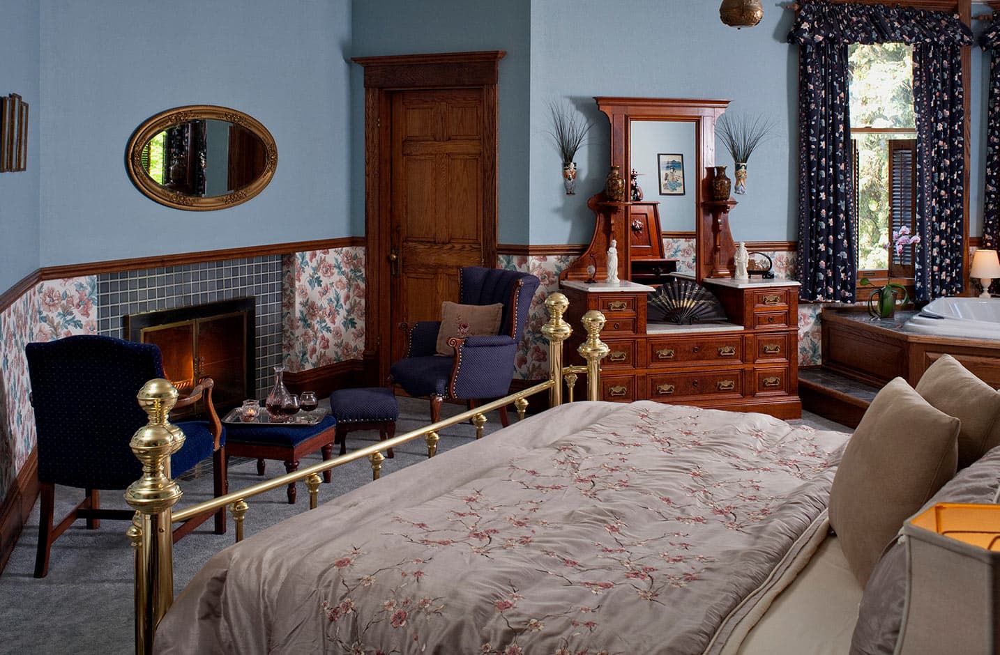 Bed and decorative fireplace in Room VII