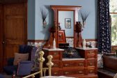 Ornate Dresser and blue side chair in Room VII