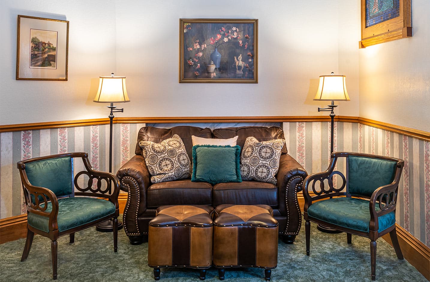 Sitting area with leather couch and chair in Room VIII