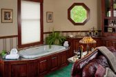 Spa tub in Suite XI with leather couch in distance