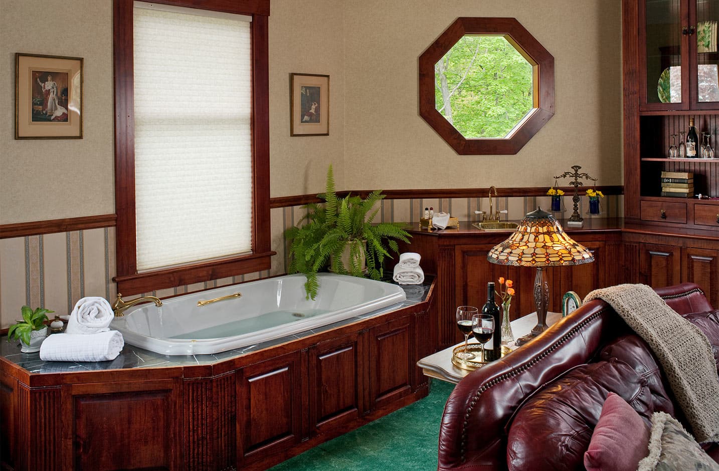 Spa tub in Suite XI with leather couch in distance