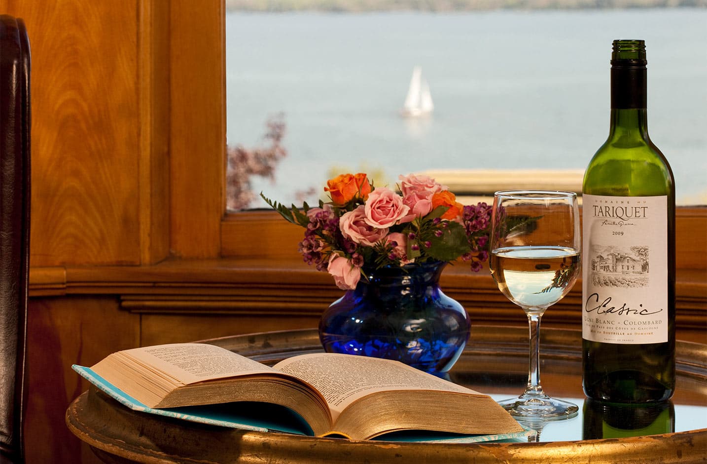 Open Book with glass of wine, wine bottle, and flowers