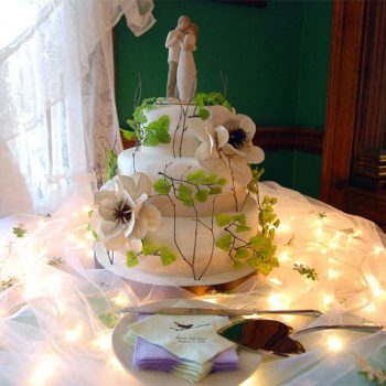beautiful wedding cake on a table with lights