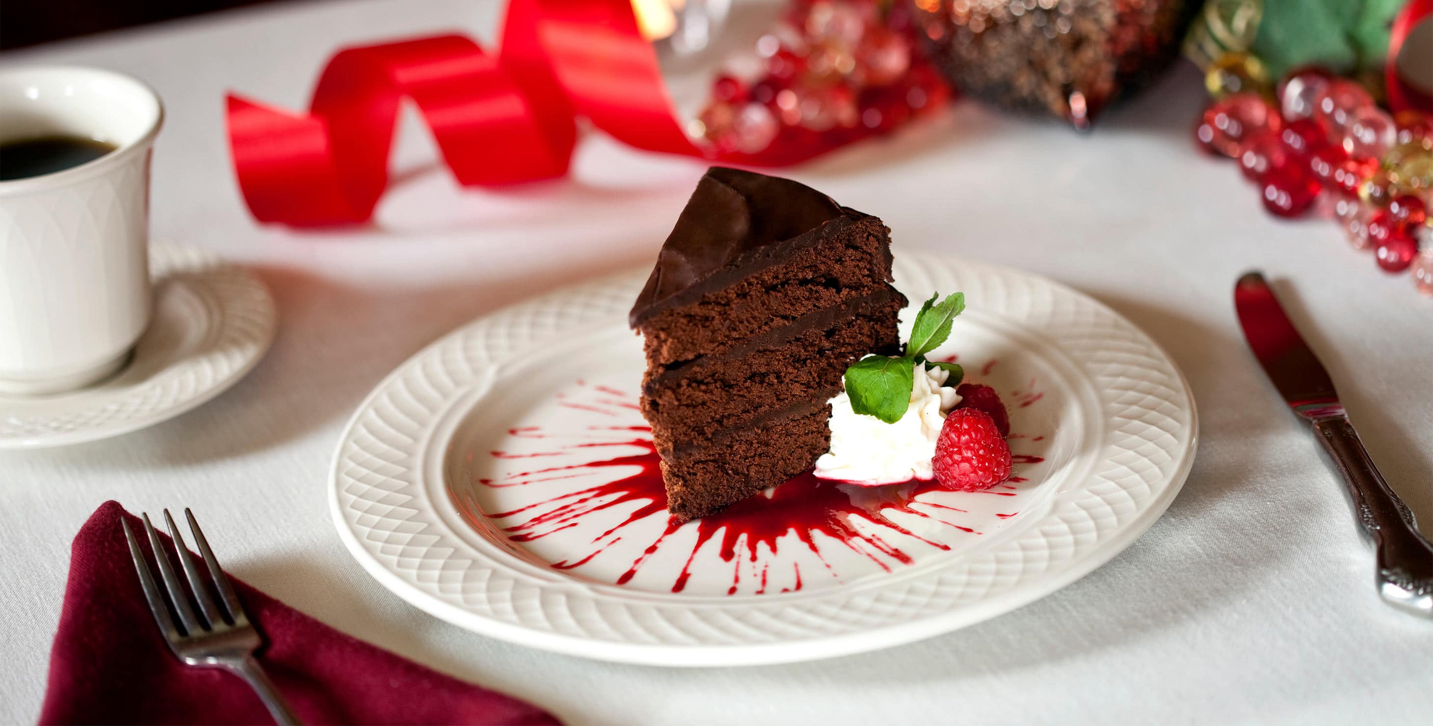 Slice of Chocolate cake with raspberry sauce