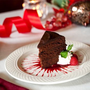 Slice of Chocolate cake with raspberry sauce