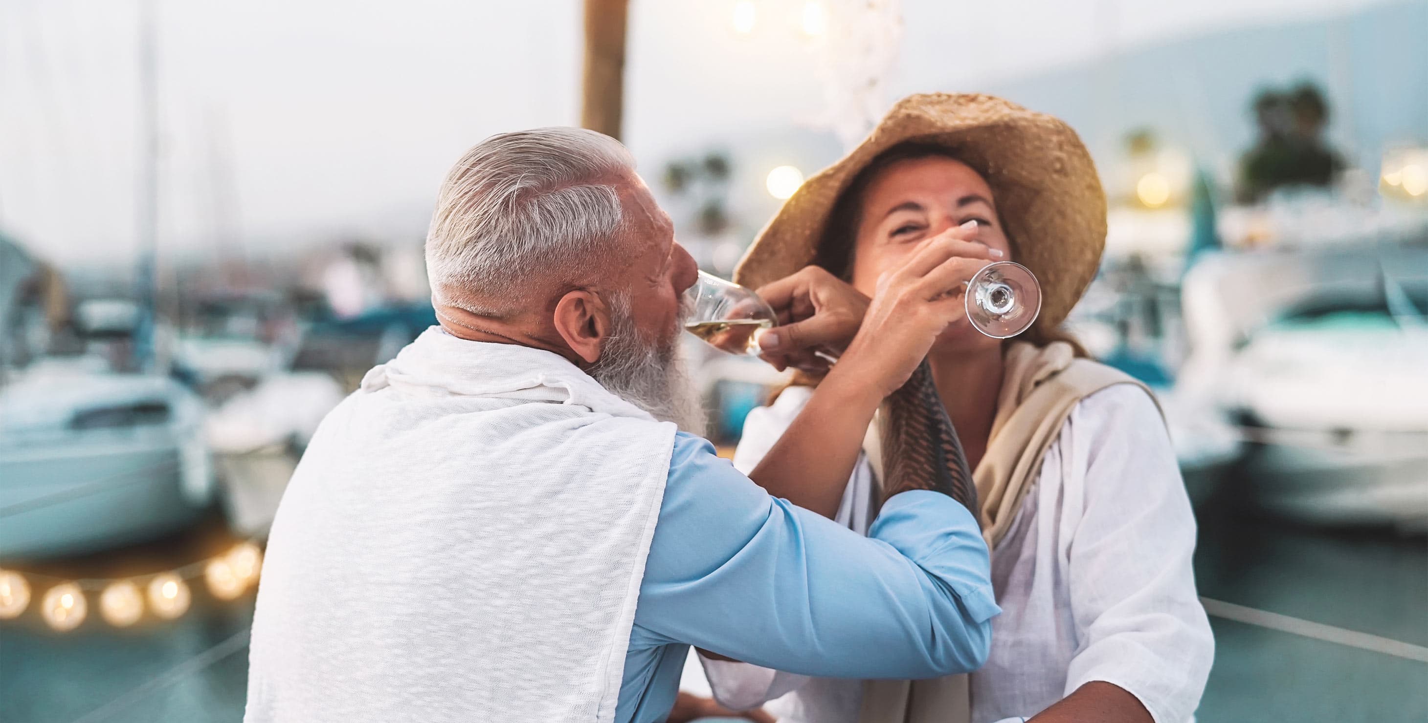 Couple drinking wine on the bow of a boat