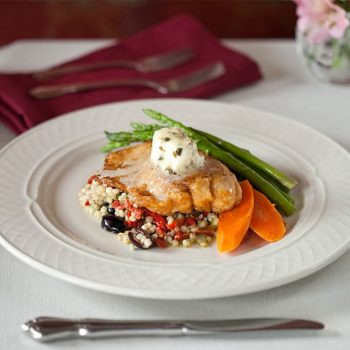 Fish Entree on a table with white wine