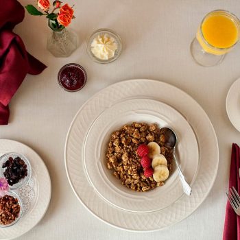 Breakfast table set with Granola bowl in the middle