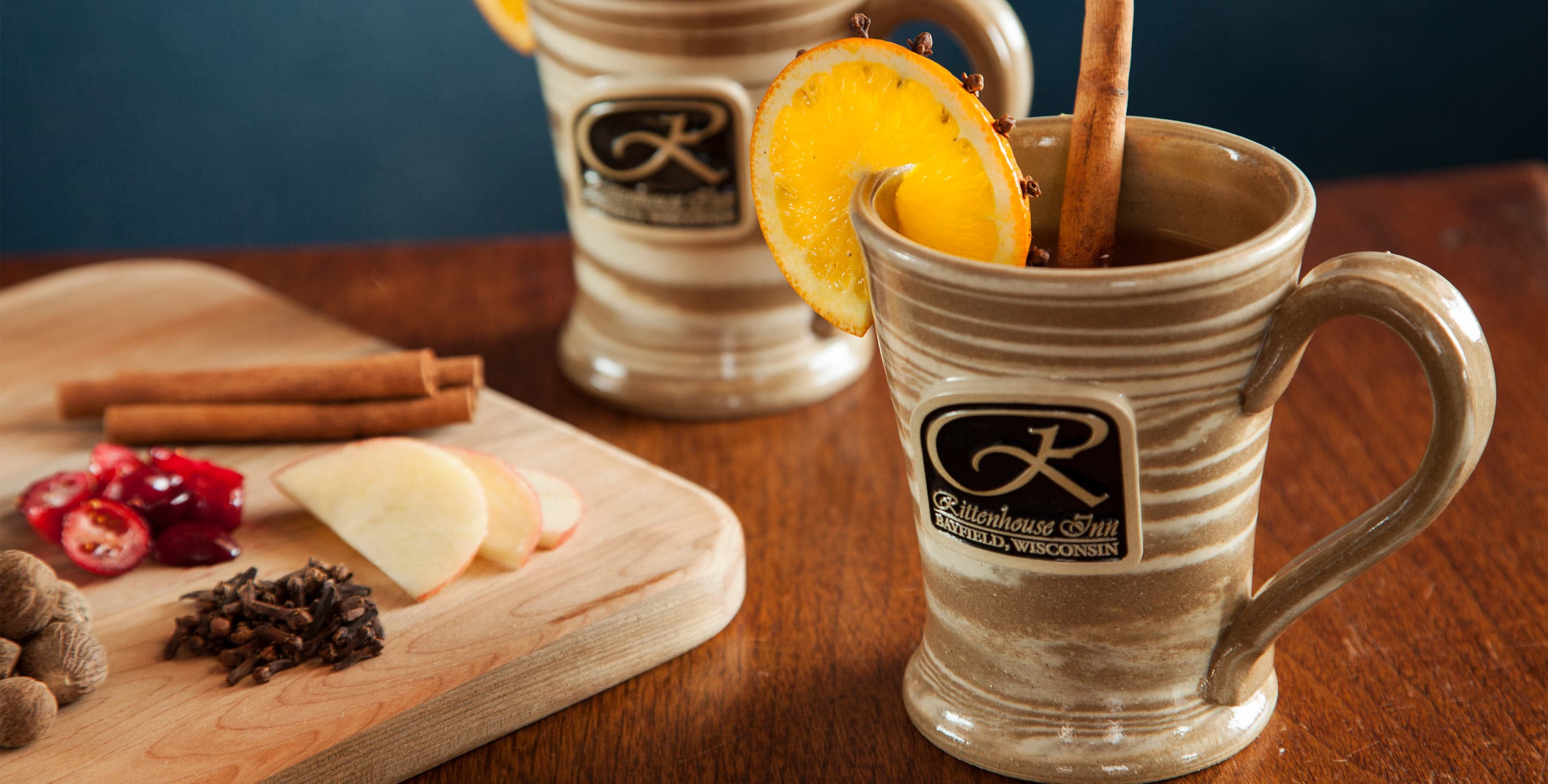 Hot drinks with cinnamon stick and lemon clove rind