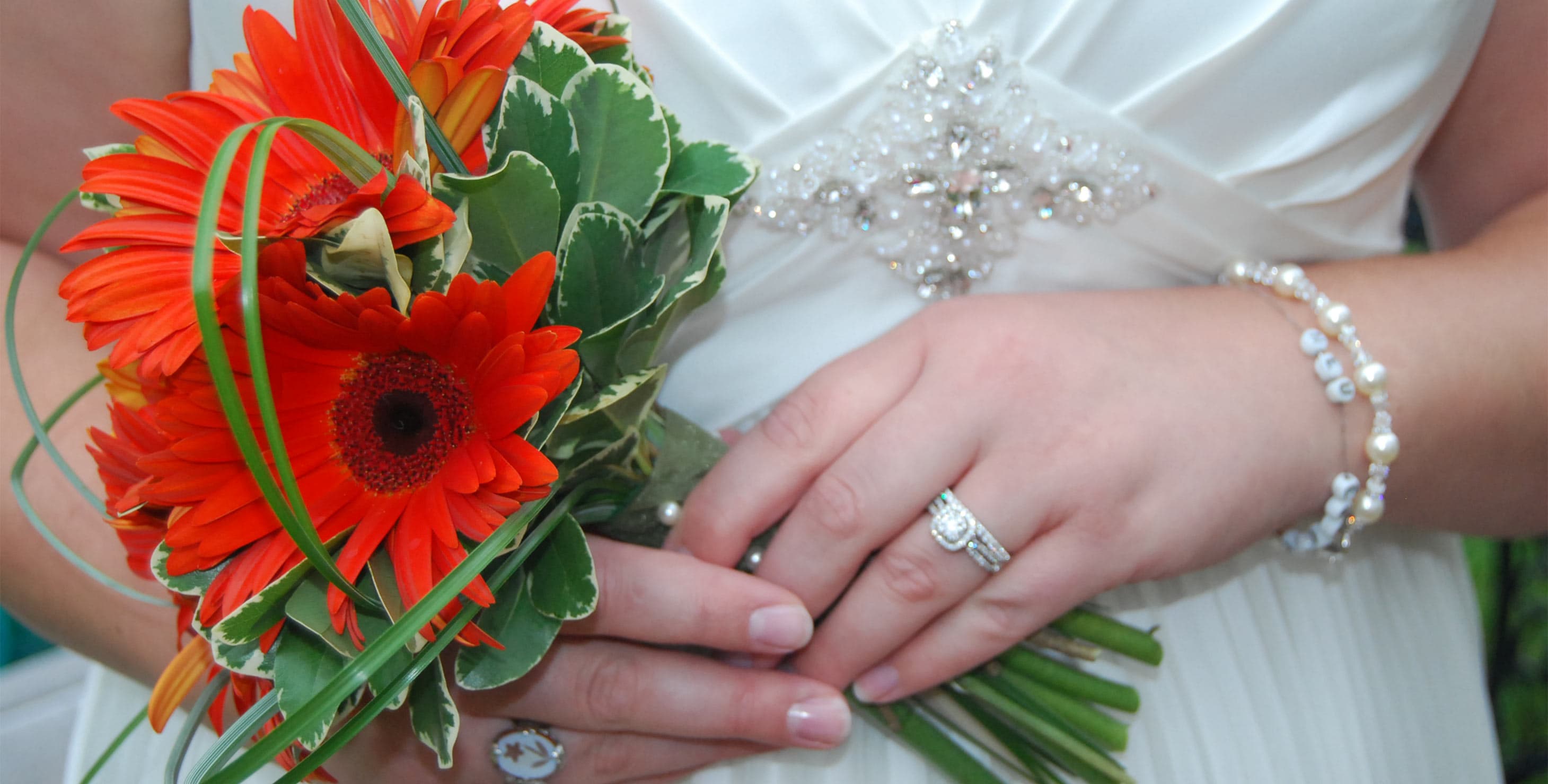 Bride Holding Simple Wedding Bouquet with red gerbera daisies