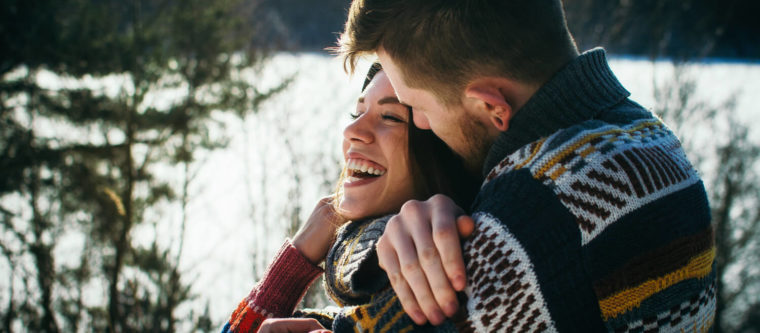 A young couple share a loving embrace while enjoying one of many Wisconsin winter getaways.