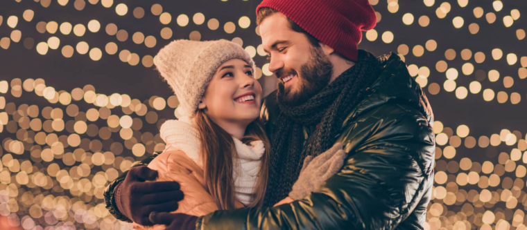 A lovely young couple smiles at each other while enjoying their romantic getaway in Wisconsin.