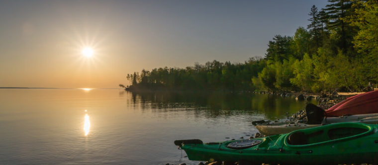 Photo of lake, trees, and canoe during a Wisconsin summer vacation