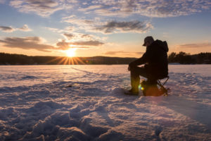 Photo of person on the lake enjoying Wisconsin ice fishing near Bayfield