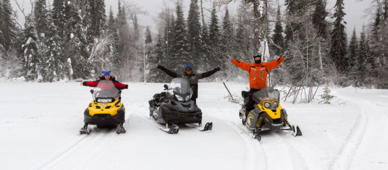 Group of three people riding the Wisconsin snowmobile trails near Bayfield