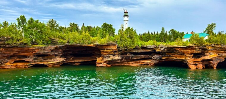 View of lighthouse and caves in Apostle Islands National Lakeshore in Wisconsin
