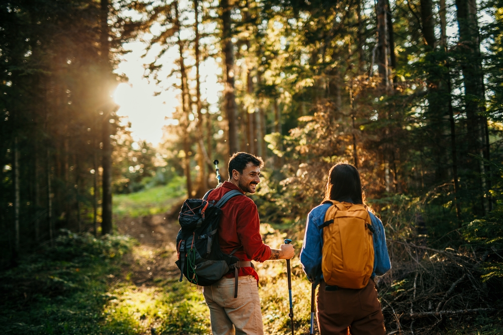 Two people with backpacks on wooded hiking trail during a weekend getaway in Wisconsin