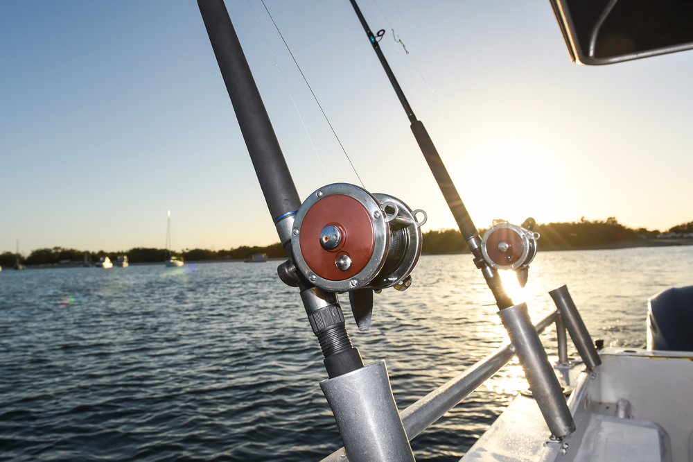 fishing rod closeup in front of water during Lake Superior fishing charters