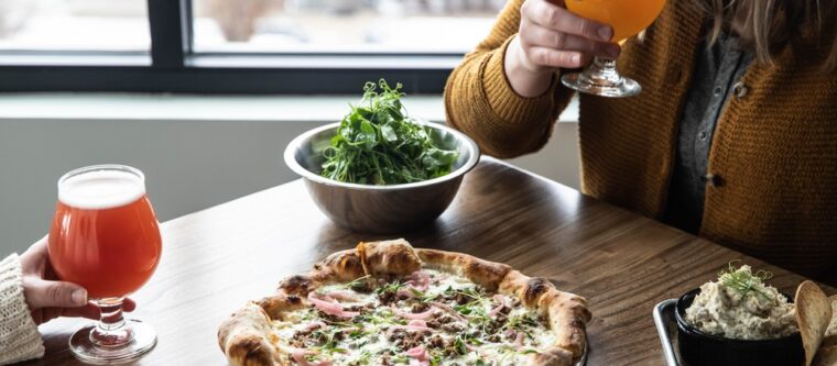 People eating pizza and drinking beer at Madeline Island restaurants